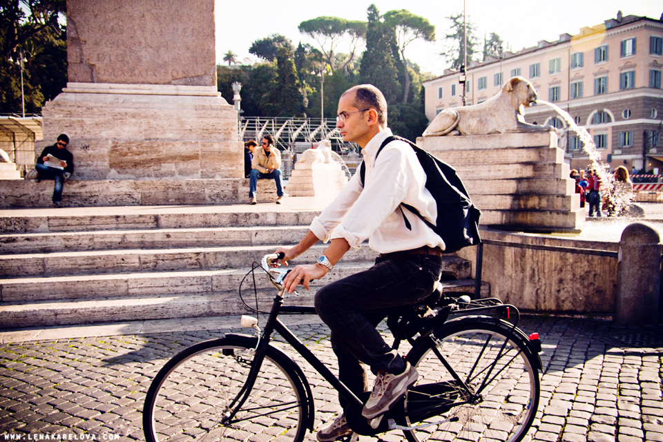 man driving a bicycle in rome
