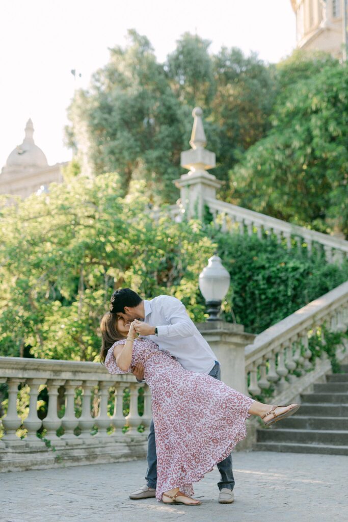 Young couple dancing after a picture perfect proposal at Montjuic, in Barcelona