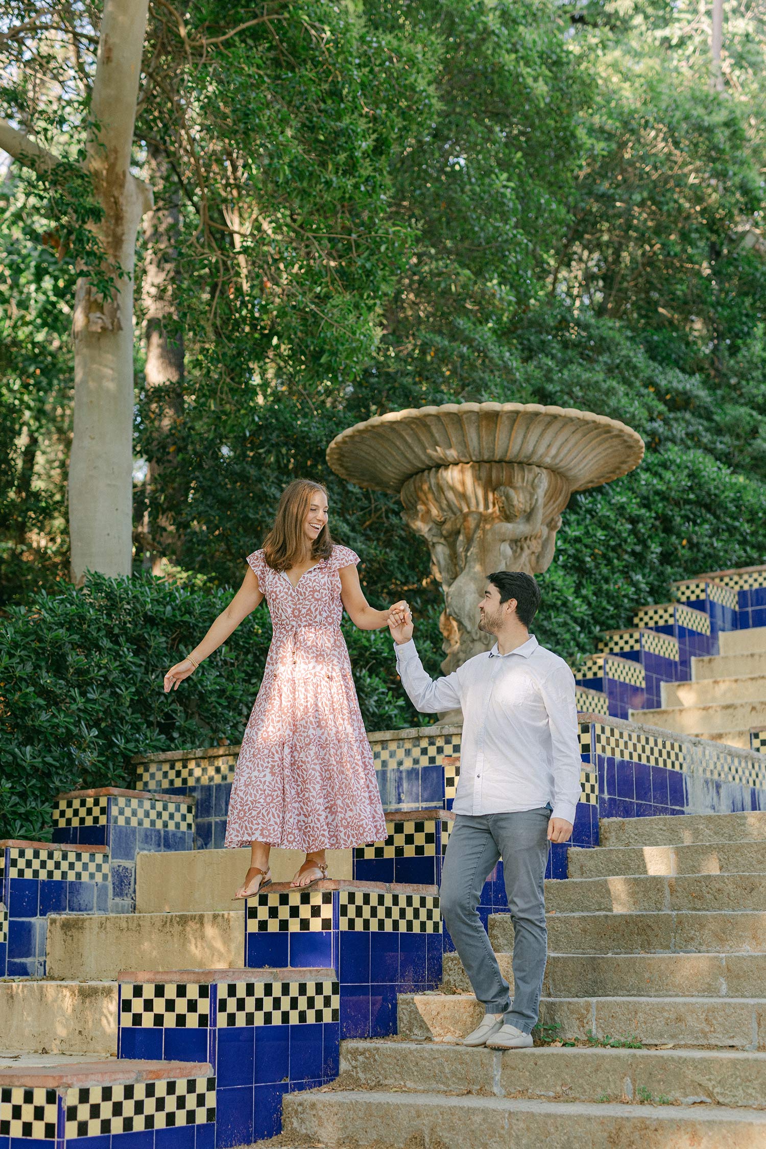 Young couple walking and having fun after the surprise marriage proposal on the top of MNAC museum in Barcelona