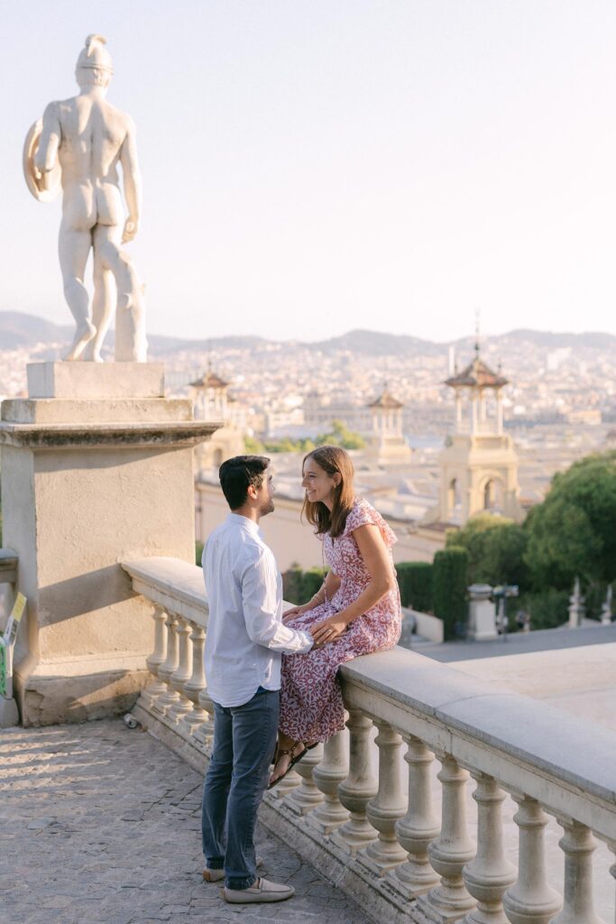 Young couple after the surprise marriage proposal on the top of MNAC museum in Barcelona