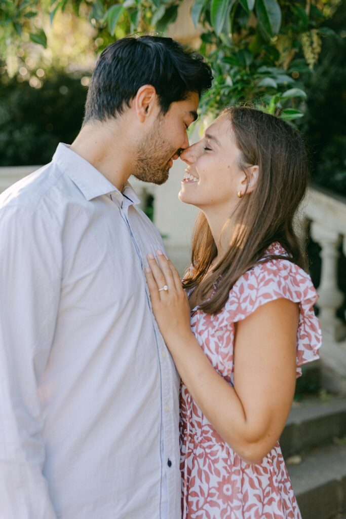 Young couple almost kissing after the surprise marriage proposal on the top of MNAC museum in Barcelona