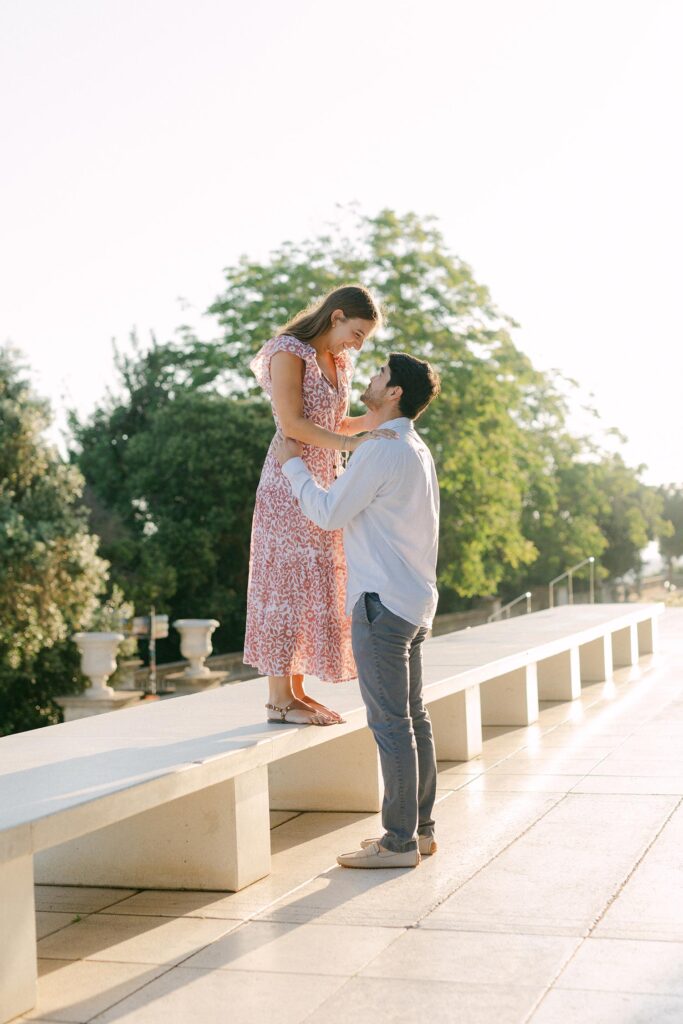 Young couple looking at each otherafter the surprise marriage proposal on the top of MNAC museum in Barcelona