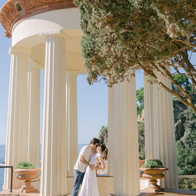 Young couple dancing at the gazebo over facing the Costa Brava