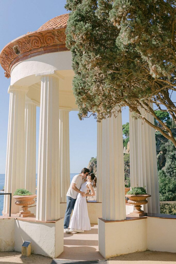 Young couple dancing at the gazebo over facing the Costa Brava